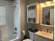 Bright bathroom featuring a white vanity, toilet, and tub/shower combination at 1913 Albany St, Beech Grove, IN 46107
