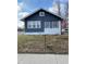 Cozy blue home featuring white trim and a patriotic star, complemented by a green yard at 1913 Albany St, Beech Grove, IN 46107