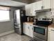Well-equipped kitchen featuring stainless steel appliances, white cabinets, and butcher block countertops at 1913 Albany St, Beech Grove, IN 46107