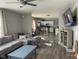 Open-concept living room with hardwood floors, a gray sectional, and a view into the kitchen at 1913 Albany St, Beech Grove, IN 46107