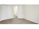 A carpeted bedroom with neutral walls and a closet with folding doors at 19499 Grassy Branch Rd, Westfield, IN 46074