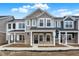 New two-story townhomes with brick and siding exteriors under a blue sky at 19499 Grassy Branch Rd, Westfield, IN 46074