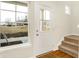 Bright foyer showcasing a front door, stairway, and large window at 19499 Grassy Branch Rd, Westfield, IN 46074