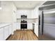 Modern kitchen featuring stainless steel appliances, white cabinets, and hardwood flooring at 19499 Grassy Branch Rd, Westfield, IN 46074
