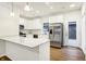Modern kitchen with white cabinets, stainless steel appliances, and quartz countertops at 19499 Grassy Branch Rd, Westfield, IN 46074