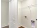 Well lit laundry room featuring utility hook ups, a wire shelf and luxury vinyl flooring at 19499 Grassy Branch Rd, Westfield, IN 46074