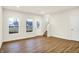Living room featuring laminate flooring, a door, staircase, and window at 19499 Grassy Branch Rd, Westfield, IN 46074