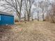 Large backyard with mature trees and a storage shed at 2370 N Moreland Ave, Indianapolis, IN 46222