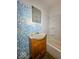Small bathroom with vintage blue wall design and a wooden sink vanity at 2370 N Moreland Ave, Indianapolis, IN 46222