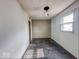 Modest bedroom featuring weathered walls and dark wood-look floors at 2370 N Moreland Ave, Indianapolis, IN 46222