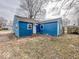 Exterior of the blue home with a white door and a fenced in yard at 2370 N Moreland Ave, Indianapolis, IN 46222