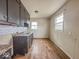 Small kitchen featuring dated cabinetry and wood-look floors at 2370 N Moreland Ave, Indianapolis, IN 46222