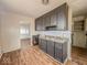 Kitchen featuring vintage cabinetry and wood-look floors at 2370 N Moreland Ave, Indianapolis, IN 46222