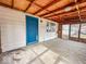 An inside view of the enclosed sunroom with concrete floor and access to the outside at 2370 N Moreland Ave, Indianapolis, IN 46222
