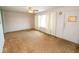 A light filled living room featuring carpet, neutral paint, and window with curtains at 26270 State Road 19, Arcadia, IN 46030