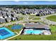 Aerial view of the community featuring a pool, tennis court, and clubhouse at 2710 Nampa Dr, Whitestown, IN 46075