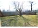 Backyard featuring mature shade trees, patchy grass and a wooden fence at 2908 N Colorado Ave, Indianapolis, IN 46218