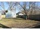 A large backyard with a new wood fence, mature trees, and a green hose at 2908 N Colorado Ave, Indianapolis, IN 46218