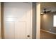 A freshly painted white door opens to a room with a fan and modern light fixture at 2908 N Colorado Ave, Indianapolis, IN 46218