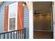 Exterior of home featuring blue siding, dark trim, orange shutters and modern light fixture at 2908 N Colorado Ave, Indianapolis, IN 46218