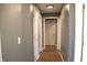 Hallway featuring light-gray paint, white paneled doors and wood flooring at 2908 N Colorado Ave, Indianapolis, IN 46218