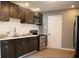 Modern kitchen featuring sleek dark cabinets, stainless steel appliances, and stylish subway tile backsplash at 2908 N Colorado Ave, Indianapolis, IN 46218