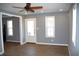 Well-lit living room with wood floors and multiple windows creating a bright and airy atmosphere at 2908 N Colorado Ave, Indianapolis, IN 46218