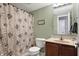 Charming bathroom with a vanity and floral shower curtain at 3079 Limber Pine Dr, Whiteland, IN 46184