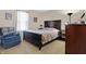 Comfortable bedroom with a plush armchair and natural light at 3079 Limber Pine Dr, Whiteland, IN 46184