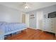 This bedroom offers hardwood floors, natural light, and ample closet space at 3079 Limber Pine Dr, Whiteland, IN 46184