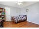 Comfortable bedroom with hardwood floors and a purple flower patterned comforter at 3079 Limber Pine Dr, Whiteland, IN 46184