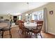Well-lit dining room showcases hardwood floors and an elegant lighting fixture above the round table at 3079 Limber Pine Dr, Whiteland, IN 46184