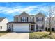 Charming two-story home with a two-car garage and well-maintained front lawn in a residential neighborhood at 3079 Limber Pine Dr, Whiteland, IN 46184