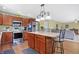 Bright kitchen with stainless steel appliances, a central island, and an open layout to the living area at 3079 Limber Pine Dr, Whiteland, IN 46184