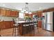 Spacious kitchen features stainless steel appliances, a kitchen island with bar stools, and plentiful cabinet space at 3079 Limber Pine Dr, Whiteland, IN 46184