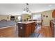 Open kitchen and dining area offers a kitchen island with seating and hardwood flooring at 3079 Limber Pine Dr, Whiteland, IN 46184