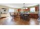 Open-concept kitchen and dining area with hardwood floors, island with bar stools, and ample cabinet space at 3079 Limber Pine Dr, Whiteland, IN 46184