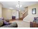Bright living room features neutral decor, plush carpet, wood floors, a staircase, and comfortable seating at 3079 Limber Pine Dr, Whiteland, IN 46184