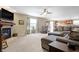 Spacious living room with a fireplace, plush seating, and an open layout to the kitchen at 3079 Limber Pine Dr, Whiteland, IN 46184