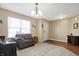 Cozy living room with neutral walls, plush carpeting, a large window, and comfortable seating at 3079 Limber Pine Dr, Whiteland, IN 46184
