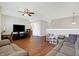 Open living area with hardwood flooring and a large screen TV at 3079 Limber Pine Dr, Whiteland, IN 46184