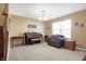 Spacious living room with neutral walls, plush carpet, and a window for lots of natural light at 3079 Limber Pine Dr, Whiteland, IN 46184
