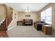 Open living area with stairs, neutral walls, carpet and hardwood floors, with piano at 3079 Limber Pine Dr, Whiteland, IN 46184