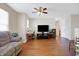 Bright living room with hardwood floors, natural light, and cozy furniture at 3079 Limber Pine Dr, Whiteland, IN 46184