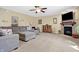 Comfortable living room with a fireplace, soft carpeting, and generous seating arrangements at 3079 Limber Pine Dr, Whiteland, IN 46184