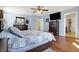 This main bedroom features wood floors, a ceiling fan, and a television at 3079 Limber Pine Dr, Whiteland, IN 46184