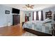 This main bedroom features hardwood floors, a ceiling fan, and a built in bookcase at 3079 Limber Pine Dr, Whiteland, IN 46184