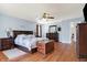 This main bedroom features hardwood floors, a ceiling fan, and a large storage chest at 3079 Limber Pine Dr, Whiteland, IN 46184