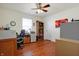This office space includes wood floors, a ceiling fan, desk space, and a storage cabinet at 3079 Limber Pine Dr, Whiteland, IN 46184