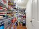 Walk-in pantry features metal shelving stocked with food items and plenty of storage space at 3079 Limber Pine Dr, Whiteland, IN 46184